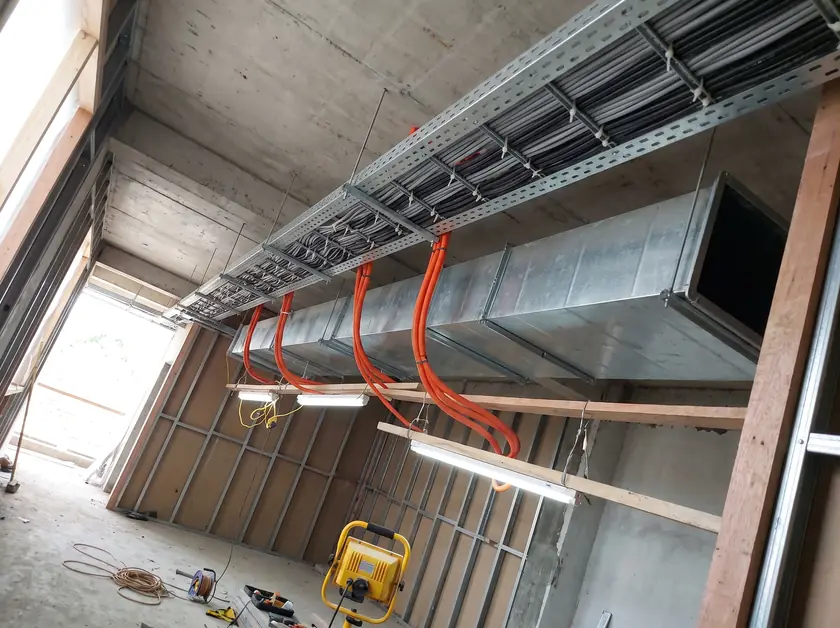 Cable tray with neatly tied power cables above a restaurant fit-out in Denpasar